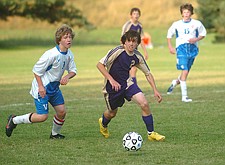 Trevor Moll pushes the ball up for the Polson Pirates.