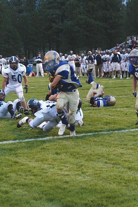 Jason Shueh/Valley Press Bluehawk Richard Lyons pushes past the Loyola Rams defense for a four-yard rush into the end zone. It was the only touchdown of the night for the Bluehawks.