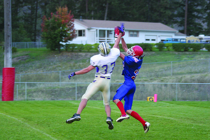 Goofy Erickkson snatches the ball just before the Cut Bank player can grab it in the homecoming game last Friday.