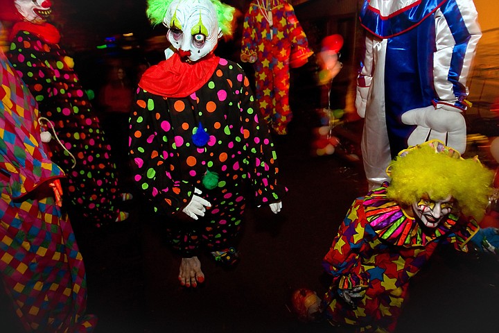 &lt;p&gt;One of the creepy clowns walks through a group of his hanging companions waiting to scare Scarywood visitors.&lt;/p&gt;