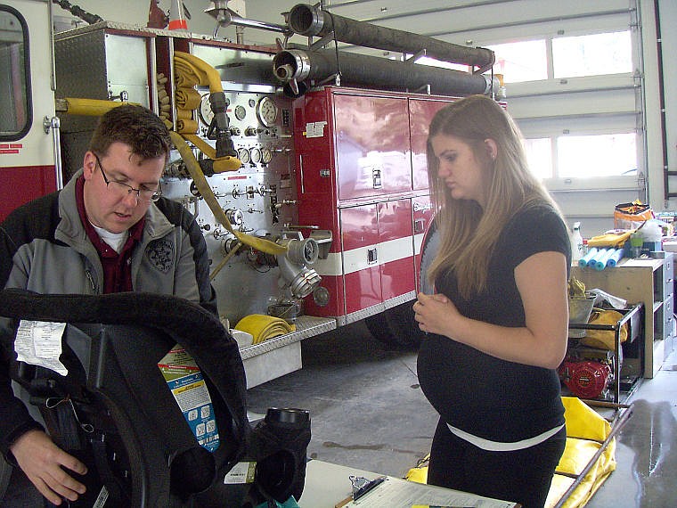 &lt;p&gt;Montana Highway Patrol Trooper Steve Spurr shows a resident how to properly install a child safety seat during an event in September.&lt;/p&gt;