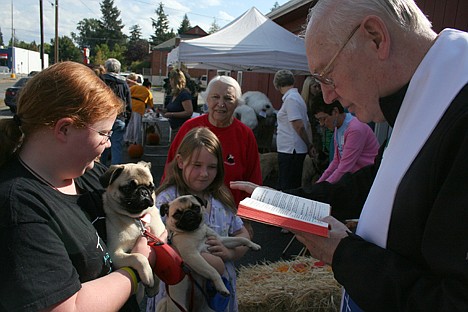 &lt;p&gt;Father Roger LaChance gives a blessing on Saturday for pugs Pudgy and Francis, held by two of the Cahill children, at Kootenai Humane Society's pet blessing.&lt;/p&gt;