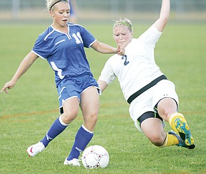 &lt;p&gt;Sophomore defensive back Breanna Opland dives in an attempt to break up Hailey Purdy's shot on goal Tuesday vs. C-Falls.&lt;/p&gt;