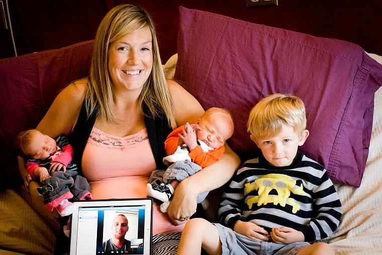 <p>Erin Zimbelman poses with twins Brielle and Braylon and their older brother Blaine and an iPad connected to Jon Zimbelman, who is in Iraq but connected to his family by Skype.</p>