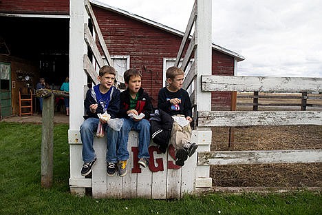 &lt;p&gt;From left: Blair Stach, 7, Danie Hisel, 7, and Brandon Olson, 7, from Spokane Valley Christian School eat a snack by the pig pen during a class field trip to visit the Prairie Home Farm in Coeur d&#146;Alene. The Prairie Home Farm is home to goats, horses, pigs, mules, geese, chickens, mules and a turkey for kids to feed.&lt;/p&gt;