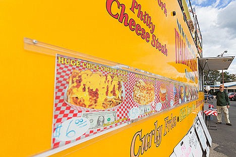 &lt;p&gt;Jean Paul Bruns, a regular customer of The Big Yellow Mobile Kitchen, picks up his order Wednesday at the food truck location near the intersection of Fourth Street and Spokane Avenue in Coeur d&#146;Alene. The owner, Tim Patterson, has concerns about a proposed city ordinance for mobile food vendors.&lt;/p&gt;