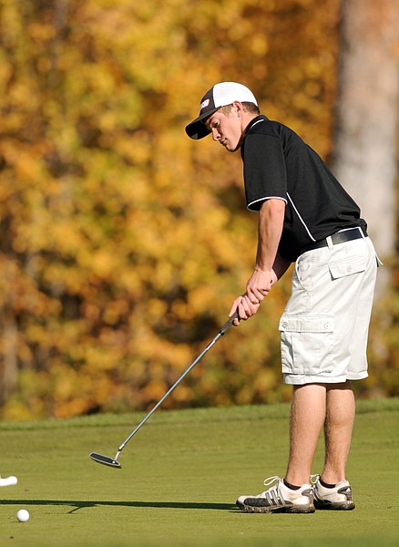 Flathead's Michael Lavin putts during day one of the Class AA state tournament on Friday at Buffalo Hills Golf Course in Kalispell.