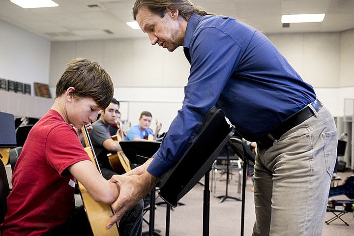 &lt;p&gt;Classical guitarist Brad Richter helps Post Falls High School freshman Ryan Christensen adjust his strumming hand positioning during a special guitar class taught by Richter on Wednesday at Post Fall High School.&#160;&lt;/p&gt;