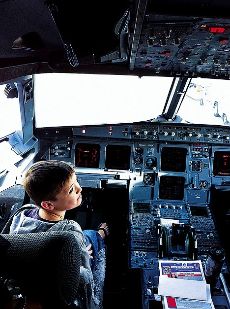 &lt;p&gt;Avery Irvin looks over his shoulder with a grin as he sits in the pilot's seat prior to departing the Spokane International Airport on Sept. 21 for his Make-A-Wish sponsored trip to Minnesota.&lt;/p&gt;