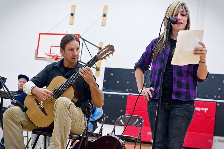 &lt;p&gt;JEROME A. POLLOS/Press Brad Richter, a world-renowned guitarist and composer, accompanies Dezziree Dewitt, 17, while she reads her poem during an assembly Wednesday at Project CDA. Richter worked with students in class to identify the type of music that would go well with the students' poetry.&lt;/p&gt;