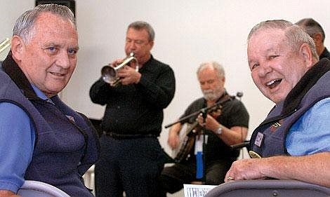 Gary Fischer, left, and John Van, co-directors of the Glacier Jazz Stampede, are pictured at the opening act of the festival Tuesday at Snappy&#146;s Sport Senter in Kalispell. Playing behind the men are the Rocky Mountain Rhythm Kings; at left on cornet is Don West, at right on banjo is Bill Rossiter. Karen Nichols/Daily Inter Lake