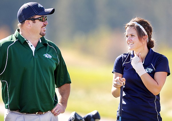 Glacier sophomore Shea Stevens talks with coach Rob Logsdon as she waits for her turn to tee off during day two of the Class AA state tournament on Saturday at Big Mountain Golf Course in Kalispell.
