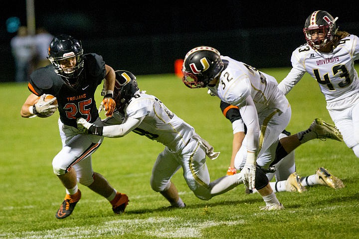 &lt;p&gt;Post Falls junior running back Braden Vaughan sheds a tackle from University's Dakota Larson on Friday, Sept. 9, 2016 at Post Falls High School.&lt;/p&gt;