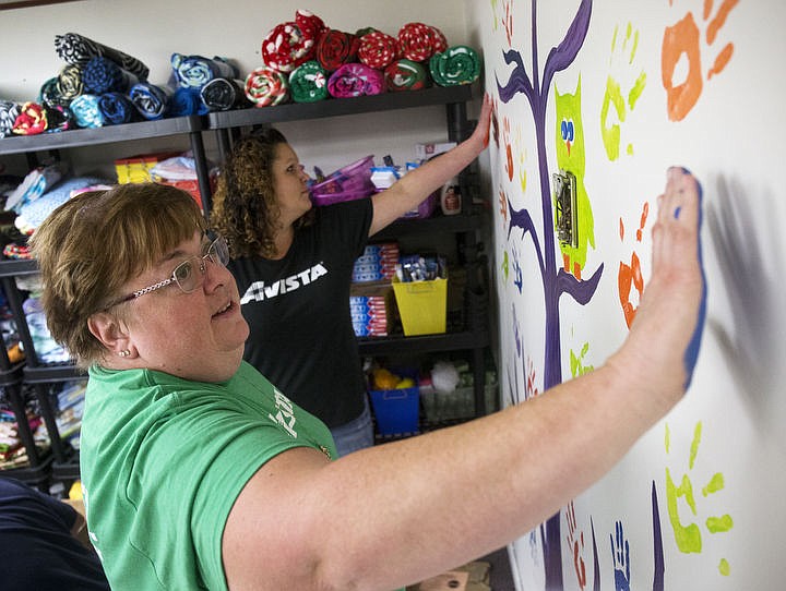 &lt;p&gt;Avista employees Jeri DeGregorio, left, and Malissa Pearson place their blue and orange hands next to a painted hand tree in the CASA Kidz Closet during Day of Caring on Thursday, Sept. 22, 2016.&#160;&lt;/p&gt;