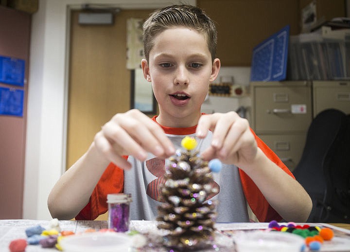 &lt;p&gt;Fifth-grader Carter Flink places a puffball onto the top of his cone during class on Tuesday, Sept 20, 2016 at Fernan Elementary School. The student decorated cones will be picked up by the United State Forest Service later in the week and delivered to Washington, D.C. to be placed on the Christmas Tree on the West Lawn of the U.S. Capitol in time for the holiday season.&lt;/p&gt;