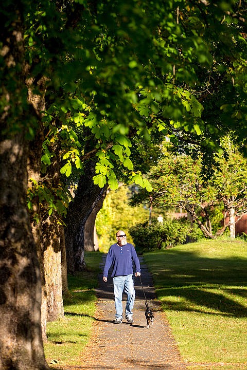 &lt;p&gt;Coeur d'Alene native Dean Swanson smiles as he and his rat terrier Bailey stroll through a patch of afternoon sunlight on Monday, Sept. 19, 2016 on Indiana Avenue. Summer temperatures are forecasted to dwindle this week, with highs in the upper 60s.&lt;/p&gt;