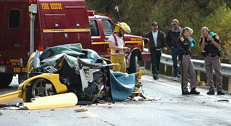 Bret Childers, right, Flathead Valley sheriff&#146;s deputy, and Flathead Coroner Dorothy Brouder talk on their cell phones while Olney Fire and Rescue firefighter James Hutchinson works the scene of a head-on collision Wednesday afternoon on U.S. 93 north of Olney. A yellow Corvette was northbound when it collided with a southbound pickup. The driver of the Corvette died at the scene, and the driver of the truck was in guarded condition Wednesday evening at Kalispell Regional Medical Center. The highway was closed to traffic for about two hours. Garrett Cheen/Daily Inter Lake