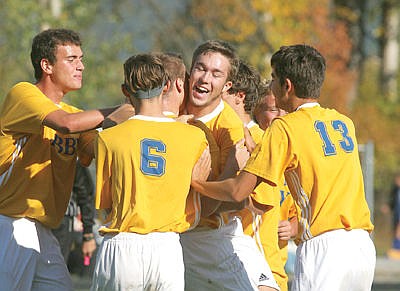 <p>Junior defender Tyler Lucas (center) is all smiles after scoring in the second half vs. Stillwater Saturday. Loggers over Cougars 2-0. (Paul Sievers/TWN)</p>