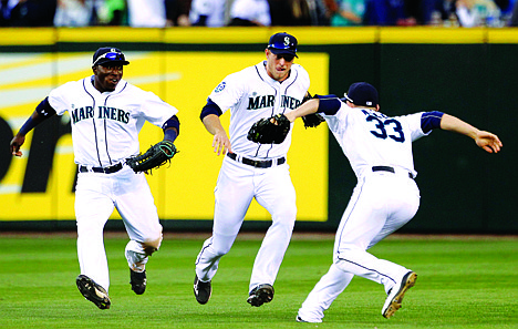 &lt;p&gt;Seattle Mariners outfielders Trayvon Robinson, left, Michael Saunders and Casper Wells (33) rush toward each other to celebrate the Mariners' 12-0 win over the Los Angeles Angels in a baseball game Wednesday, Oct. 3, 2012, in Seattle. (AP Photo/Elaine Thompson)&lt;/p&gt;