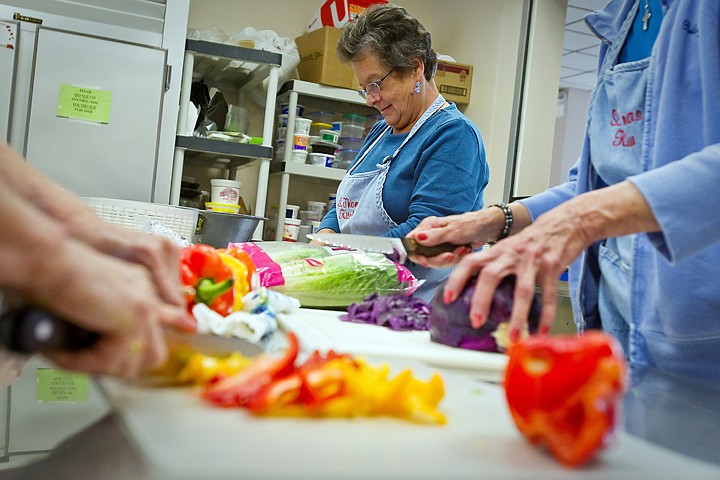 &lt;p&gt;Kathy Perez prepares lettuce for a salad as other volunteers at the St. Thomas Soup Kitchen in Coeur d'Alene prepare other vegetables for the organization's weekly dinner Tuesday.&lt;/p&gt;