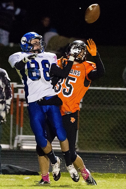 <p>SHAWN GUST/Press Post Falls High School's Axel Carlson breaks up a pass to the Vikings' Camden Doering in the first half.</p>