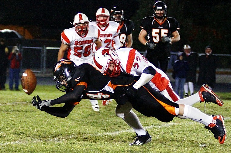 Flathead Tight End Braxton Nimmick loses control of a pass while Bozeman's Justin Pierson tackles him in the third quarter of Friday evening's game at Legends Stadium.