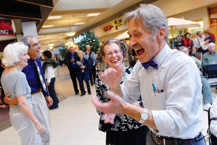 Brad Boardman claps as the band finishes a song after dancing with his wife Kaylene.