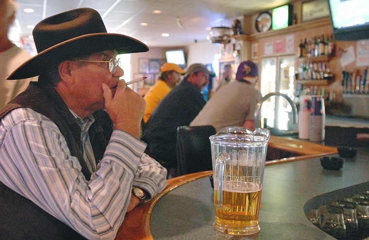 Jim Holcomb takes a drag from his cigarette after stopping in for a beer at the Kalispell VFW Tuesday afternoon. The VFW has begun repainting to eliminate the smoke smell which they hope will bring new customers when the business becomes smoke-free.