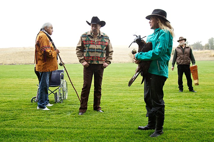 &lt;p&gt;JEROME A. POLLOS/Press Jane Cantwell holds a juvenile golden eagle as Don Veltkamp waits in the background following a ceremony where Cliff SiJohn, left, and Alfred Nomee sang tribal family songs.&lt;/p&gt;