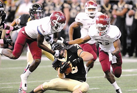 &lt;p&gt;Idaho's Justin Parkins (center) splits New Mexico State's Austin Franklin (left) and Dylan Davis (right) to secure the muffed punt by Franklin late in the first quarter. The Vandals turned the turnover into a touchdown on their wat to a 26-16 victory Saturday.&lt;/p&gt;