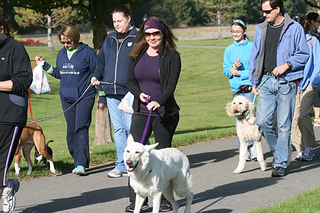 &lt;p&gt;Kristi Colacurcio, 30, of Coeur d'Alene walks her 3-year-old white German shepherd Fritz on Sunday during the 2013 Drool Stampede at Riverstone Park in Coeur d'Alene. She rescued him from euthanization in May 2012.&lt;/p&gt;