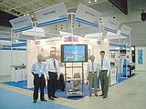 Japan initiative 1 (four people): Tamotsu Sosa, Terry Brewer, Ken-Ichi Yamaguchi and Gary Miller stand beside the Grant County booth display at the Japan Aerospace Exhibition in Yokohama.