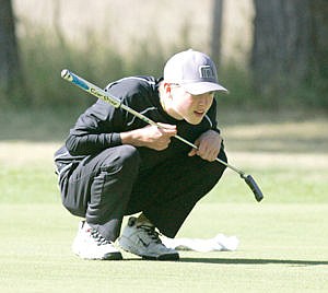 <p>Jonny Cielak studies the green on No. 2, a 356-yard par four during Libby Invite Sept. 12</p>