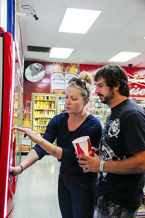 Rachel Williams, of Friday Harbor, and Dustin Kapalo, of Moses Lake, ponder on which of the 125-plus flavors they can choose from Wednesday afternoon from the Coca-Cola Freestyle machine recently installed at 1158 N. Stratford Road.