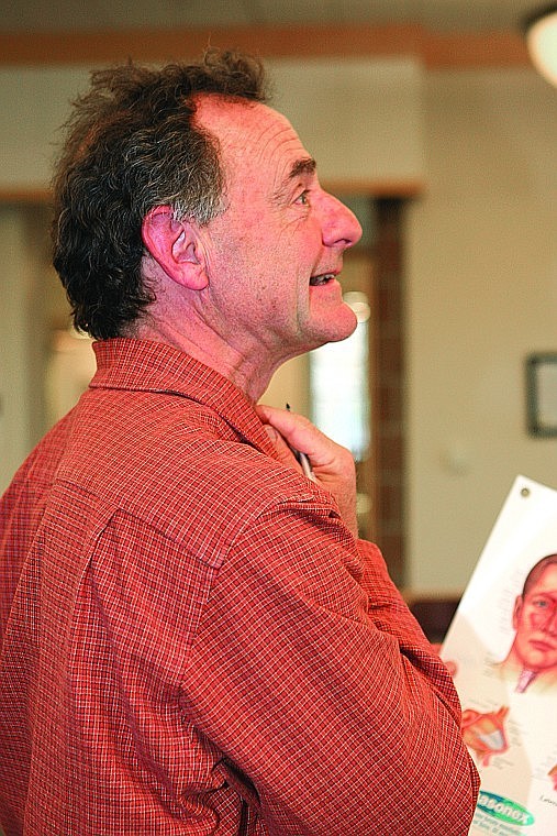 Dr. Michael Righetti, orthopedic surgeon and backcountry horse riding enthusiast led the wilderness first aid seminar at St. Joseph's Medical Center Sept. 15. Above, Righetti makes a silly face when he pokes himself in the adam's apple while trying to point out the proper place to insert a cricothyrotomy tube.