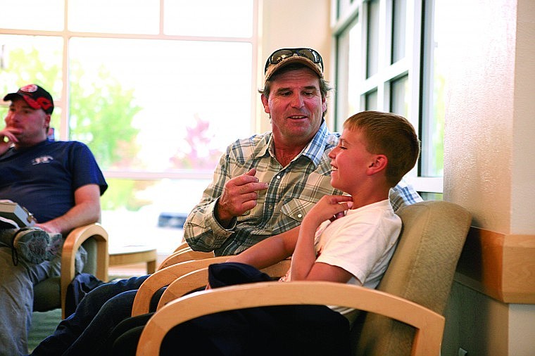 Charlo boy scout Mason McNeel works with his dad, Mark, to find the proper place to insert a cricothyrotomy tube.