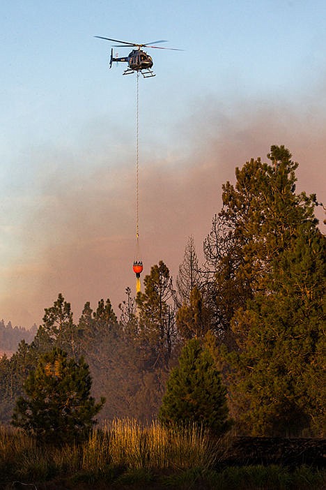 &lt;p&gt;A Forest Service helicopter drops water and fire retardant on an estimated 100-acre wildfire near Fighting Creek on Tuesday afternoon. Ground crews responded to the fire around 2 p.m. and the fire was under control by 5 p.m.&lt;/p&gt;