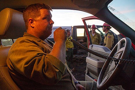 &lt;p&gt;Casey Schelin, from the Idaho Department of Lands, communicates with his crews while fighting a wildfire that started near Fighting Creek on Tuesday afternoon.&lt;/p&gt;