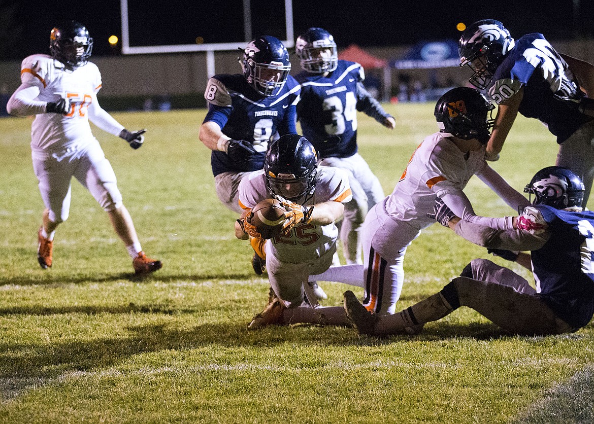 &lt;p&gt;LOREN BENOIT/Press Post Falls running back Braden Vaughan, center, leaps over the goal line for a touchdown against Lake City High School on Friday night. Vaughan rushed for 151 yards and scored four touchdowns to help propel the Trojans 35-21 over the Timberwolves.&lt;/p&gt;