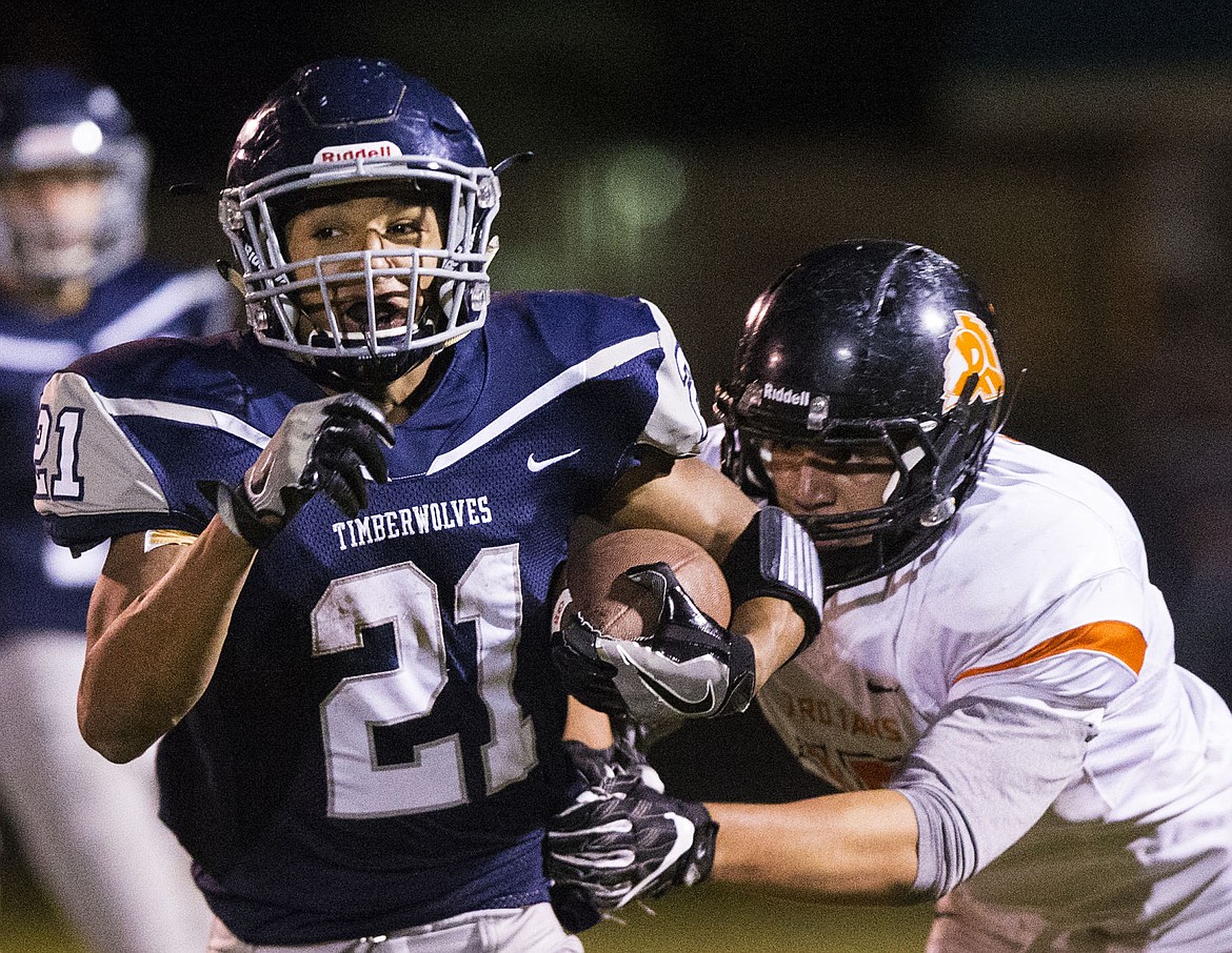 &lt;p&gt;LOREN BENOIT/Press Lake City High School running back Grant Clark breaks a tackle during Friday night's game against Post Falls High School.&lt;/p&gt;