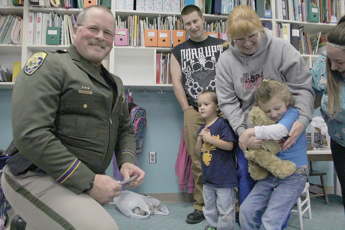 &lt;p&gt;Amber Salter-Sparks, right with teddy bear, was presented with a trip to Disney World by Montana State Trooper Sean Gaston, left.&lt;/p&gt;