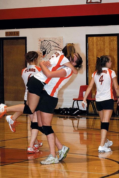 Jason Shueh/Valley Press Chelsea Roosma and Emma Ehret embrace after the team won their first game of the season against the Darby Lady Tigers.