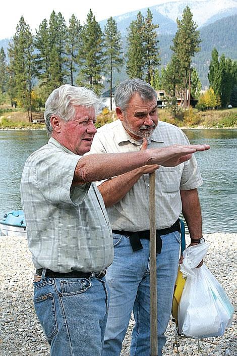 Jason Shueh/Valley Press Jon Sonju shows Johnnie Moore where the additional sediment gathered on his property.