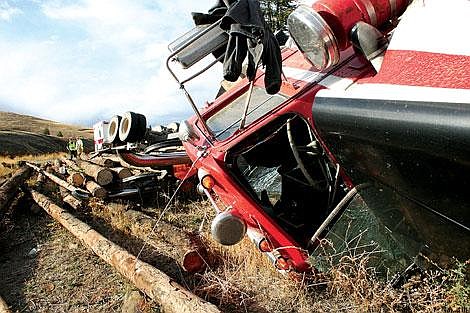 Jason Shueh/Valley Press The &#145;69 Kenworth truck rests tangled and broken in a nearby grassy field. Driver Craig Wheeler said that after the accident he had to crawl ot of the front window.