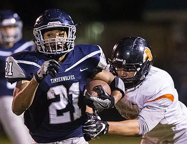 <p>Post Falls and Lake City High Schools duke it out under the lights on Friday, Oct. 7, 2016. Both the Trojans and the Timberwolves exchanged scores back and forth the first half; however, Post Falls emerged with the 35-21 win.</p>