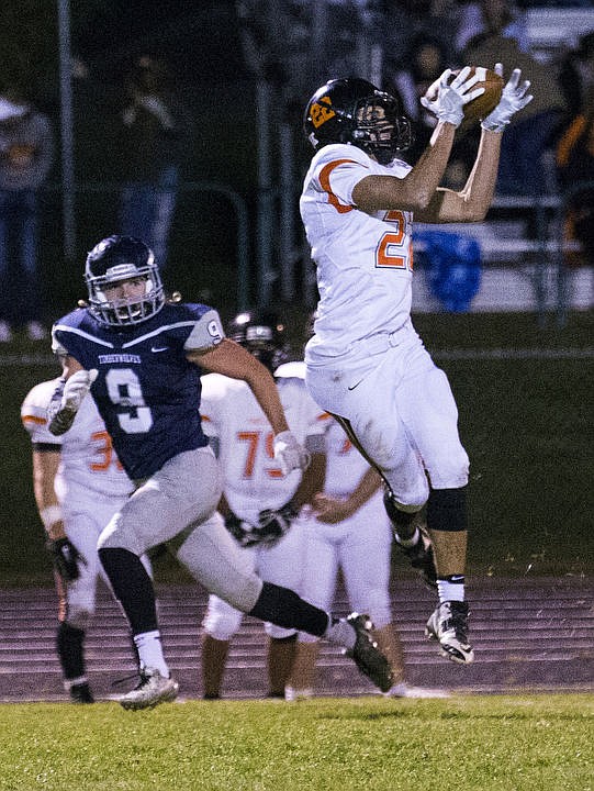 <p>Post Falls and Lake City High Schools duke it out under the lights on Friday, Oct. 7, 2016. Both the Trojans and the Timberwolves exchanged scores back and forth the first half; however, Post Falls emerged with the 35-21 win.</p>