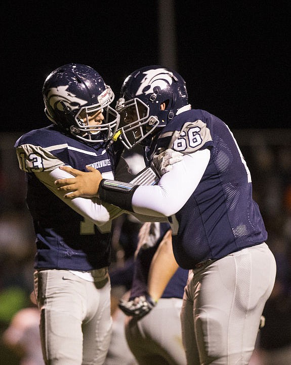 <p>Post Falls and Lake City High Schools duke it out under the lights on Friday, Oct. 7, 2016. Both the Trojans and the Timberwolves exchanged scores back and forth the first half; however, Post Falls emerged with the 35-21 win.</p>