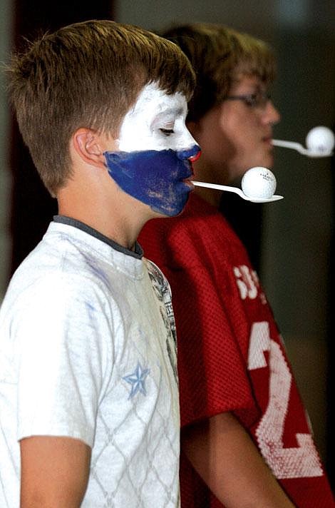 Nick Ianniello/Mineral Independent Trevor Clark, left, and Alex Billet compete in a relay race at a pep rally in Superior Friday.