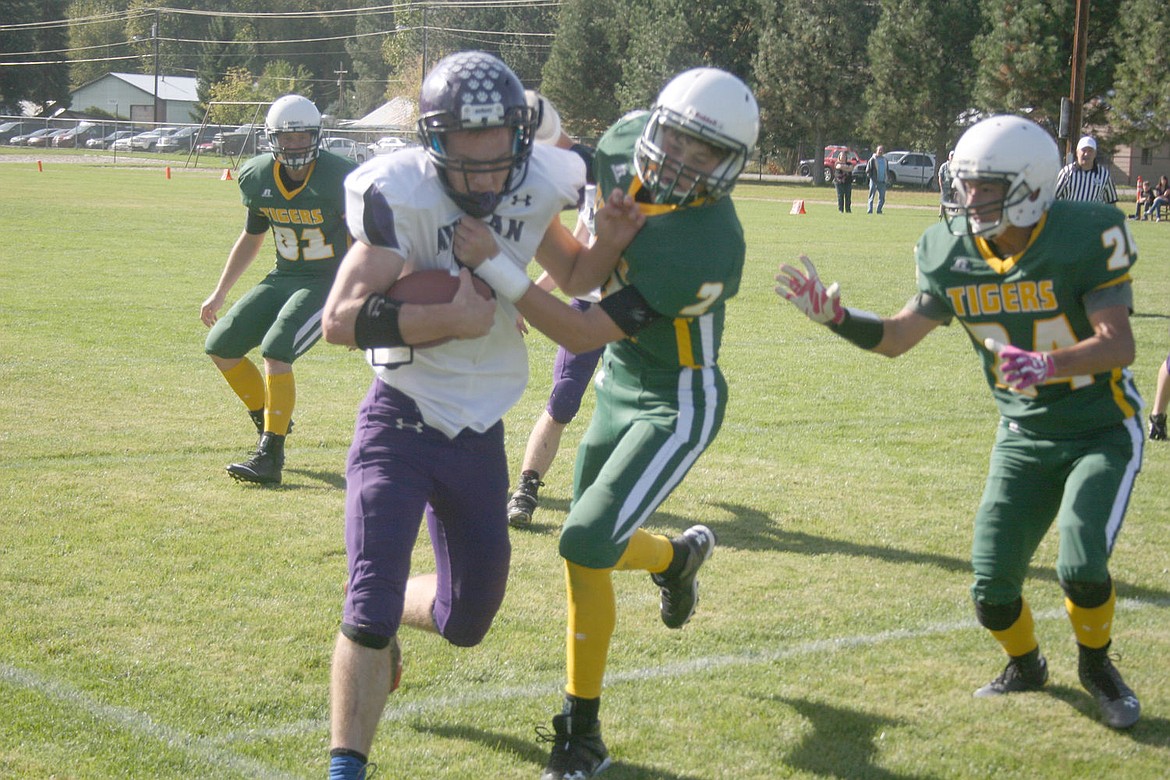 &lt;p&gt;Elias King drives a Mullan player out of bounds during last week's game in St. Regis.&lt;/p&gt;