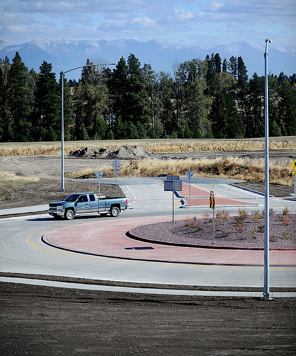 <p>A truck makes it way around the new roundabout on Hutton Ranch Road on Thursday afternoon in Kalispell.</p>